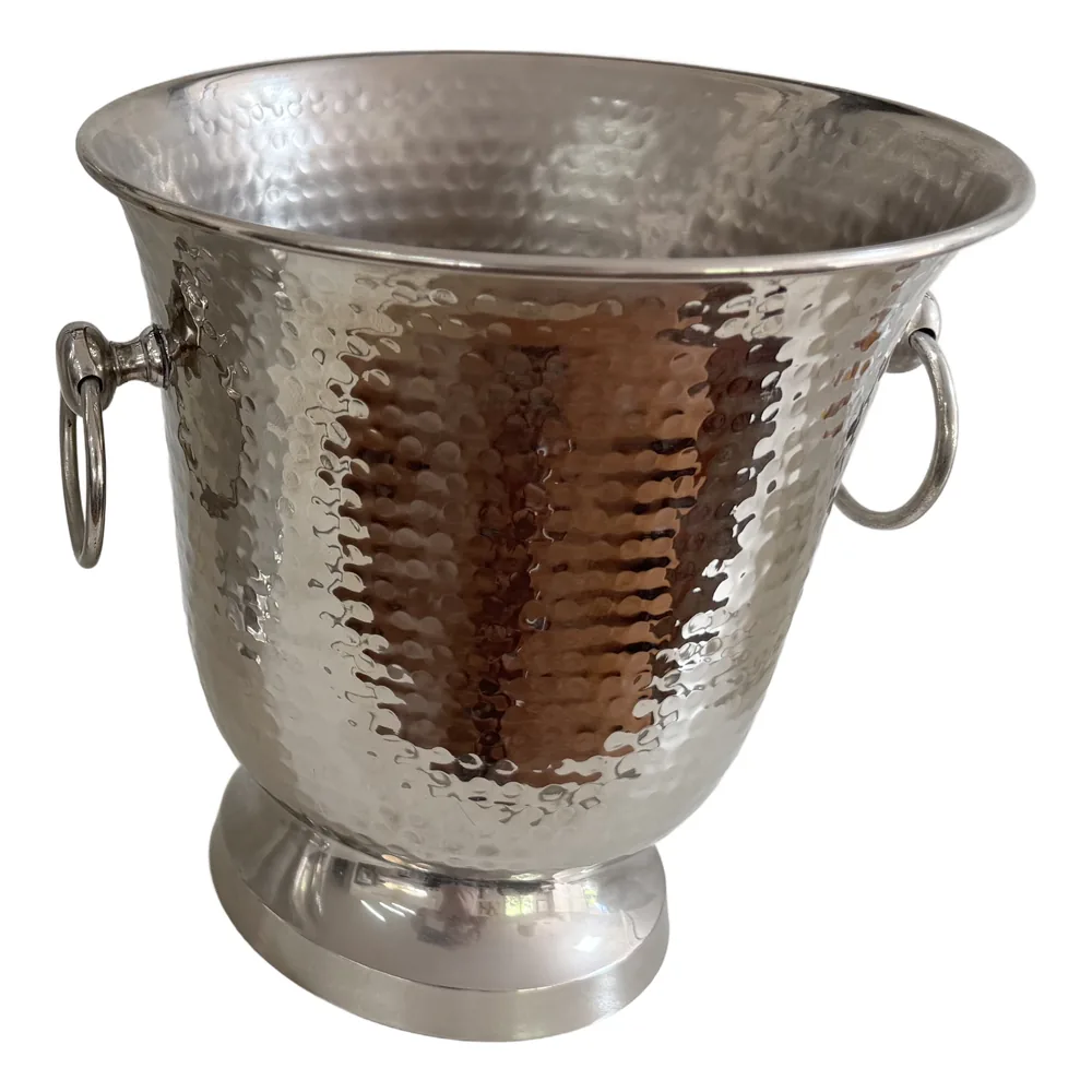 The Curl Curl ice bucket, hammered steel with ring handles on a footed base