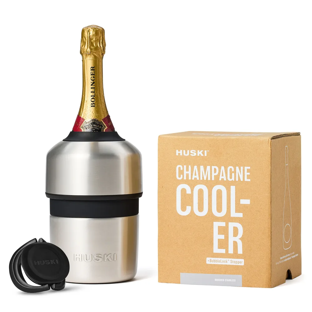 Huski Champagne Cooler in brushed stainless steel with a bottle of champagne in it, and its bottle stopper