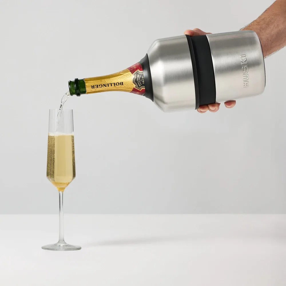 Pouring champagne into a flute straight from the Huski Champagne Cooler