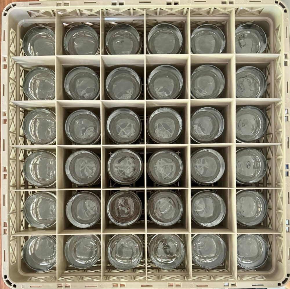A crate of 36 highball glasses from above, each glass in its own slot
